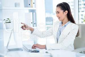 Smiling businesswoman pointing her screen