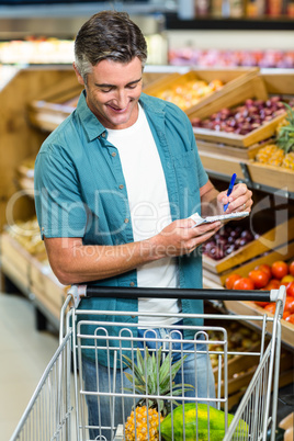 Smiling man looking at his list