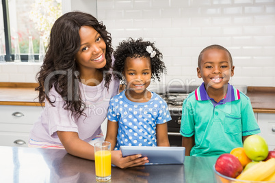 Mother and children using tablet