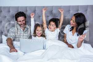 Happy children rejoicing after shopping online