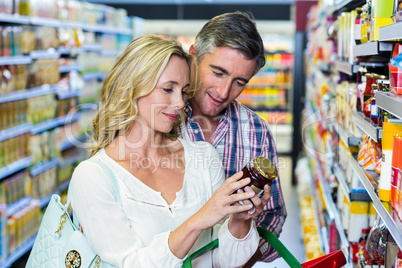 Couple reading nutritional values of food