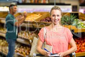 Smiling woman holding the grocery list