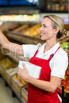 Smiling seller holding white plastic bag
