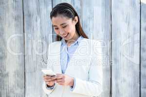 Smiling businesswoman using smartphone