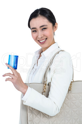 Smiling woman with a credit card in hand