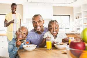 Casual happy family having breakfast