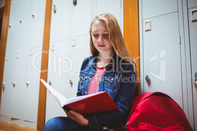 Focused student sitting and studying on notebook