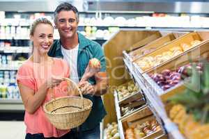 Happy couple holding potatoes