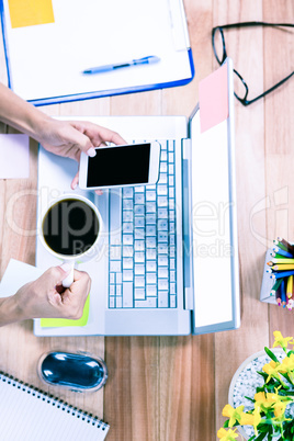 Overhead of feminine hands using smartphone and holding coffee m