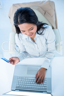 Smiling businesswoman holding credit card