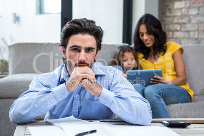 Worried father in living room looking at the camera