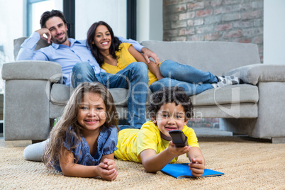 Smiling family in living room looking tv