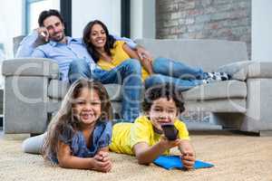 Smiling family in living room looking tv