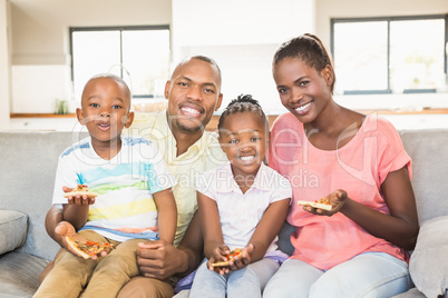 Portrait of a family of four watching tv