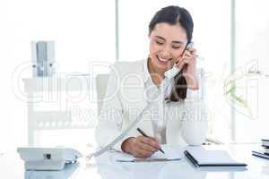 Smiling businesswoman using her telephone