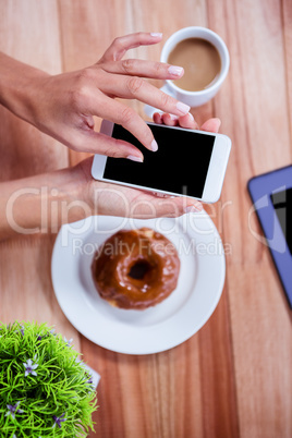 Overhead of feminine hands using smartphone