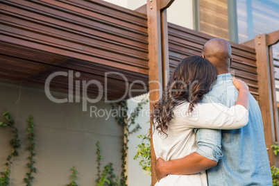 Couple with arms above after buying house