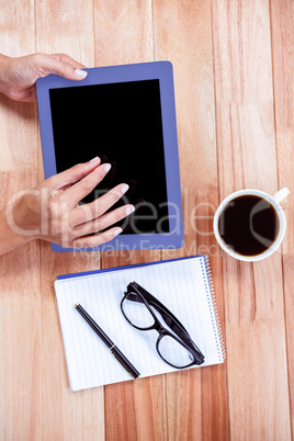 Overhead of feminine hands using tablet