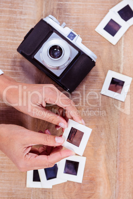 View of hands holding photo slides