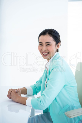 Smiling businesswoman sitting on her chair