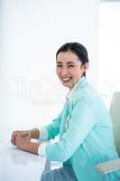 Smiling businesswoman sitting on her chair