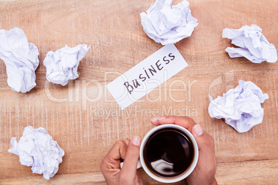 Businesswoman holding black coffee cup