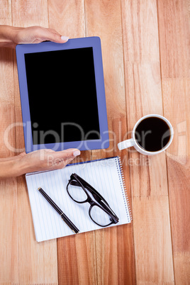 Overhead of feminine hands using tablet