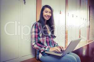 Smiling student sitting at the computer