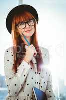 Smiling hipster woman writing notes