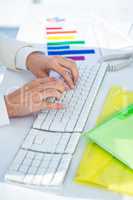 Businesswoman using her pc with documents