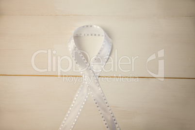 White ribbon on wooden desk