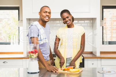 Young casual couple making fruits