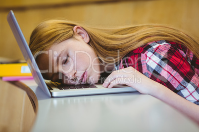 Blonde student sleeping on laptop