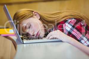 Blonde student sleeping on laptop