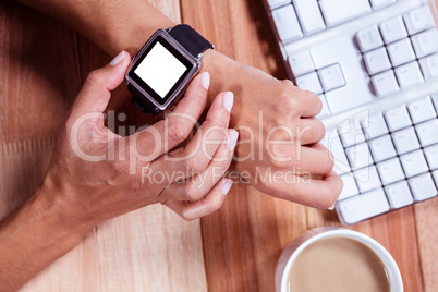 Feminine hands with smartwatch and coffee