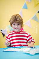 Smiling boy finger painting