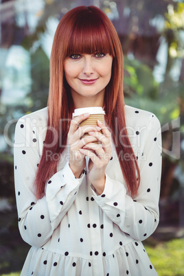 Attractive smiling hipster woman with take-away cup