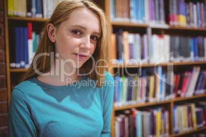 Blond student in library looking at the camera