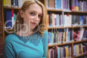 Blond student in library looking at the camera