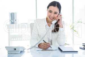 Smiling businesswoman using her telephone