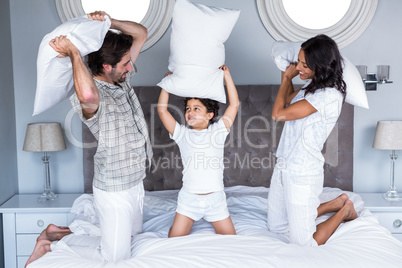 Happy family pillow fighting