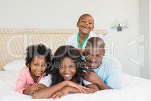 Family having fun together in bed