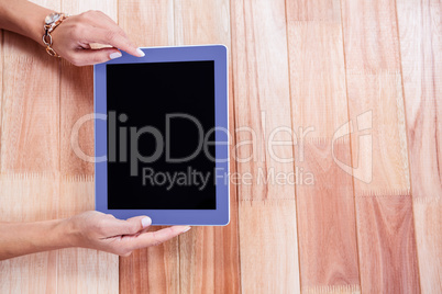 Overhead of feminine hands using tablet