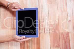Overhead of feminine hands using tablet