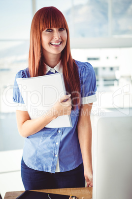 Smiling hipster woman holding document