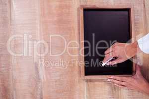 View of hand writing on blackboard