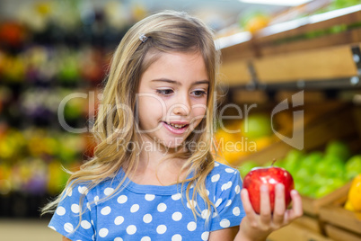 Cure girl holding an apple