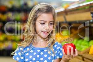 Cure girl holding an apple