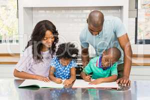 Parents helping children doing homework