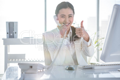 Smiling businesswoman using her telephone